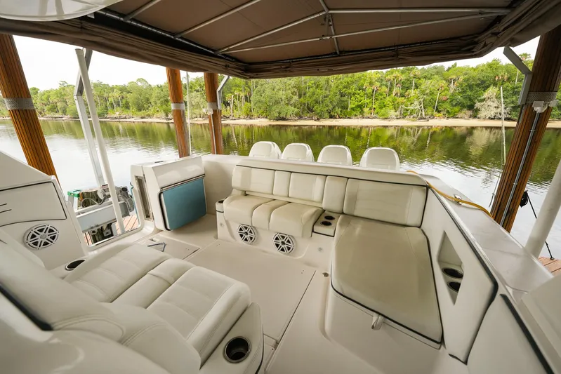  Yacht Photos Pics Luxurious seating area on a 2015 Cigarette 42 Huntress boat, docked by a serene river.