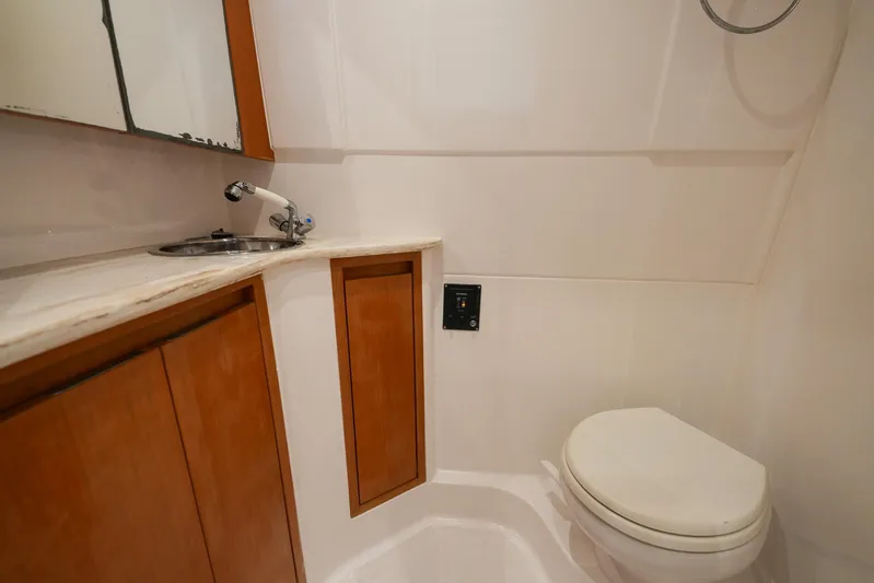  Yacht Photos Pics 2015 Cigarette 42 Huntress bathroom with wooden cabinets and compact design.