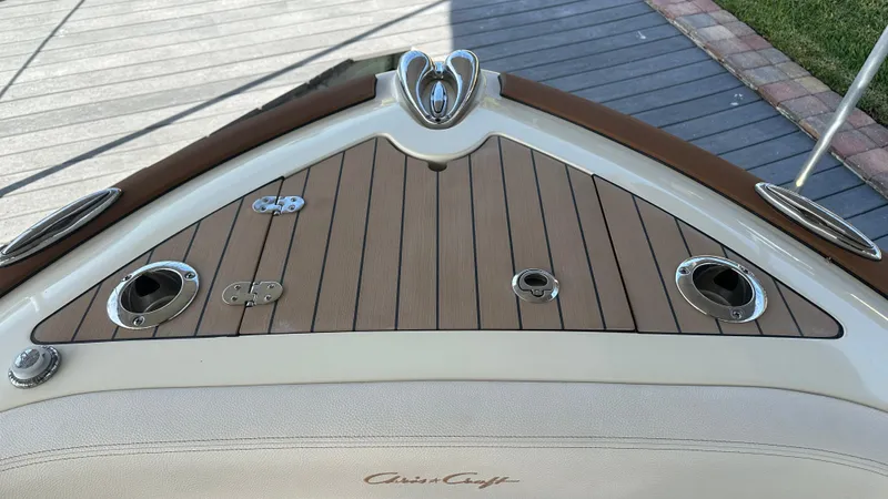  Yacht Photos Pics 2023 Chris-Craft Catalina 24 boat deck with wood finish and chrome fittings.