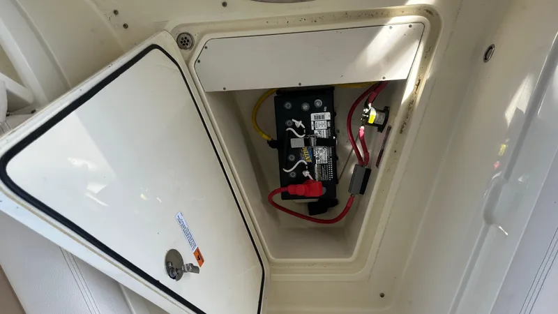  Yacht Photos Pics 2023 Chris-Craft Catalina 24 battery compartment with wiring and open hatch.