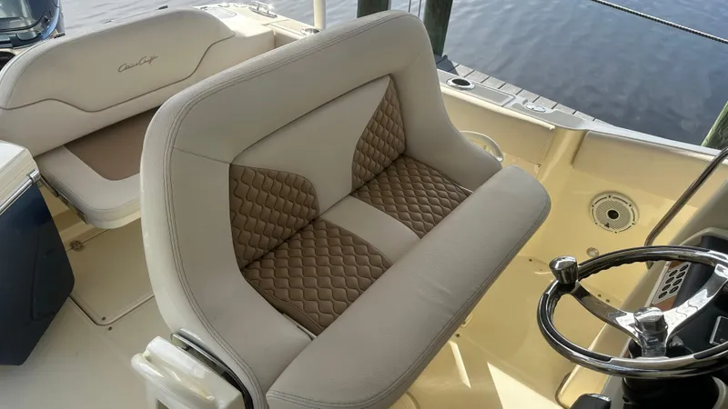  Yacht Photos Pics 2023 Chris-Craft Catalina 24 boat interior with stylish seating and steering wheel.