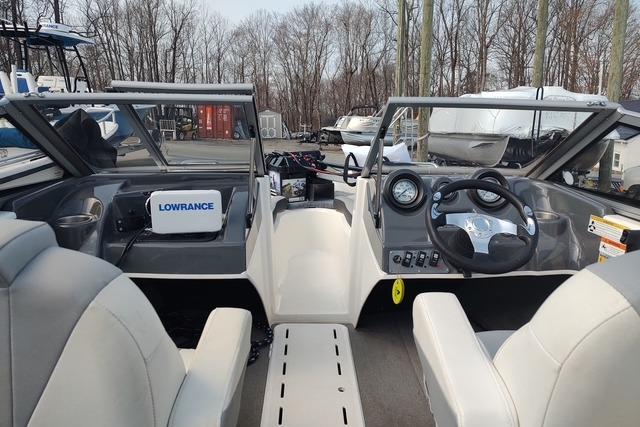 2014 Larson LX 160S OB boat interior with steering wheel and Lowrance equipment.