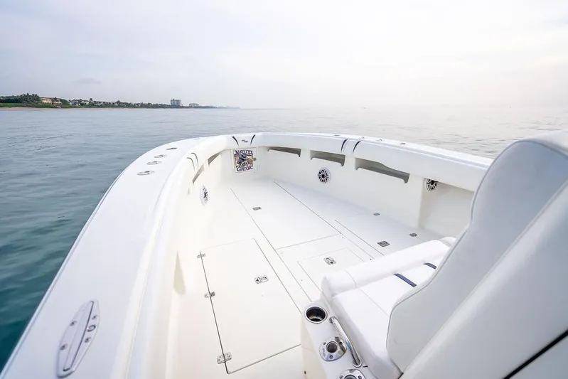 Nauti Gator Yacht Photos Pics 2014 SeaVee 34 boat, spacious deck, calm ocean view, sleek white design.