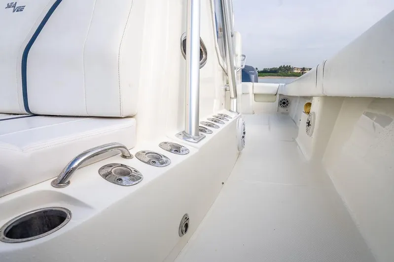 Nauti Gator Yacht Photos Pics 2014 SeaVee 34 boat interior with white seating and rod holders.