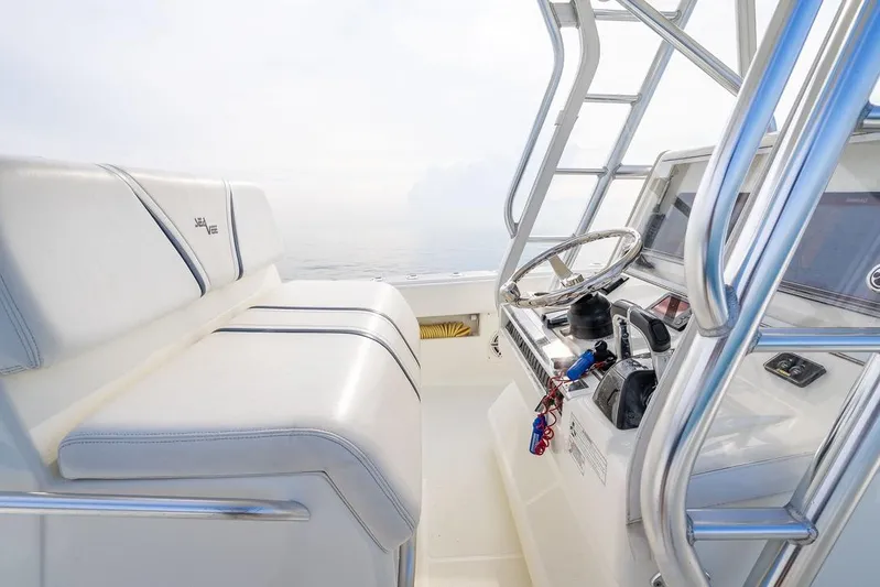 Nauti Gator Yacht Photos Pics 2014 SeaVee 34 boat interior with steering wheel and seating, showcasing sleek design.