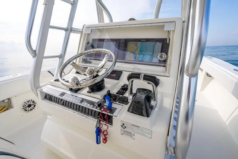 Nauti Gator Yacht Photos Pics 2014 SeaVee 34 boat helm with steering wheel and navigation system.