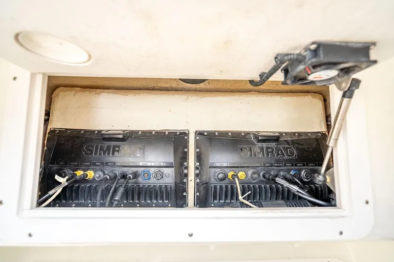 Nauti Gator Yacht Photos Pics Simrad electronics in 2014 SeaVee 34 boat compartment, showcasing wiring and installation.