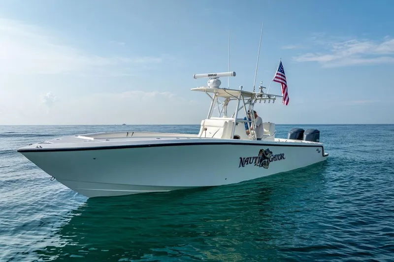Nauti Gator Yacht Photos Pics 2014 SeaVee 34 boat on calm ocean with American flag, clear sky background.