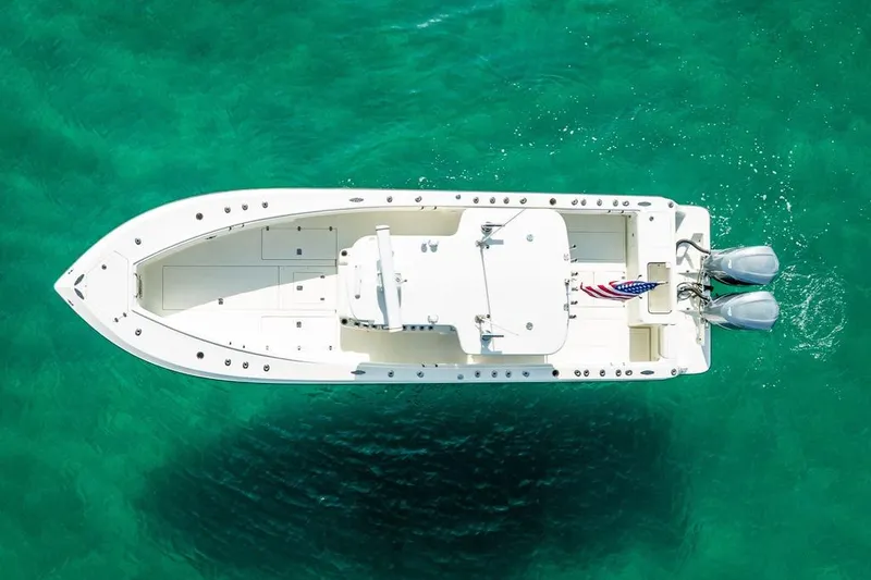 Nauti Gator Yacht Photos Pics Aerial view of 2014 SeaVee 34 boat on clear turquoise water.