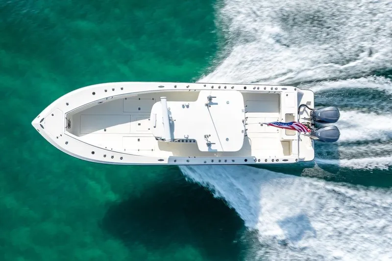 Nauti Gator Yacht Photos Pics Overhead view of 2014 SeaVee 34 boat cruising on turquoise water.