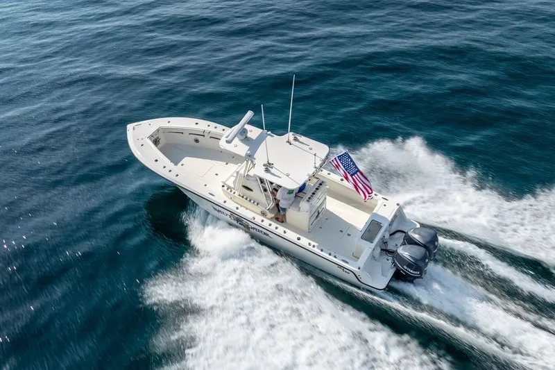 Nauti Gator Yacht Photos Pics 2014 SeaVee 34 boat cruising on open water with American flag.