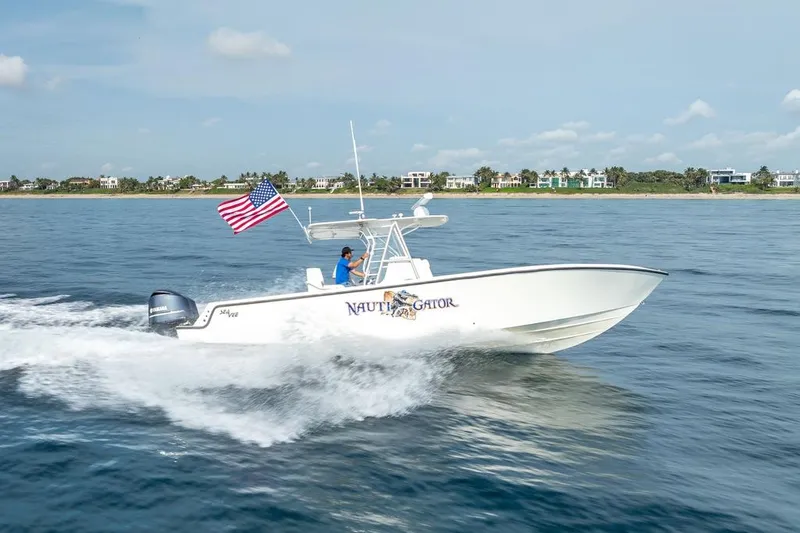 Nauti Gator Yacht Photos Pics 2014 SeaVee 34 boat cruising with American flag on open water.