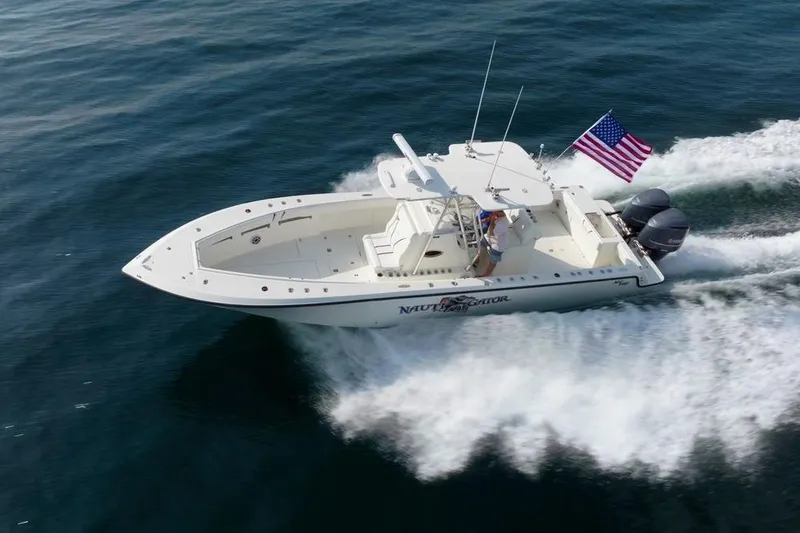 Nauti Gator Yacht Photos Pics 2014 SeaVee 34 boat cruising on open water with American flag.
