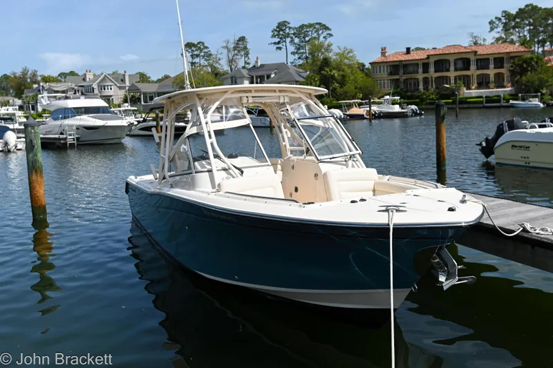  Yacht Photos Pics 2019 Grady-White Freedom 275 boat docked in a scenic marina setting.