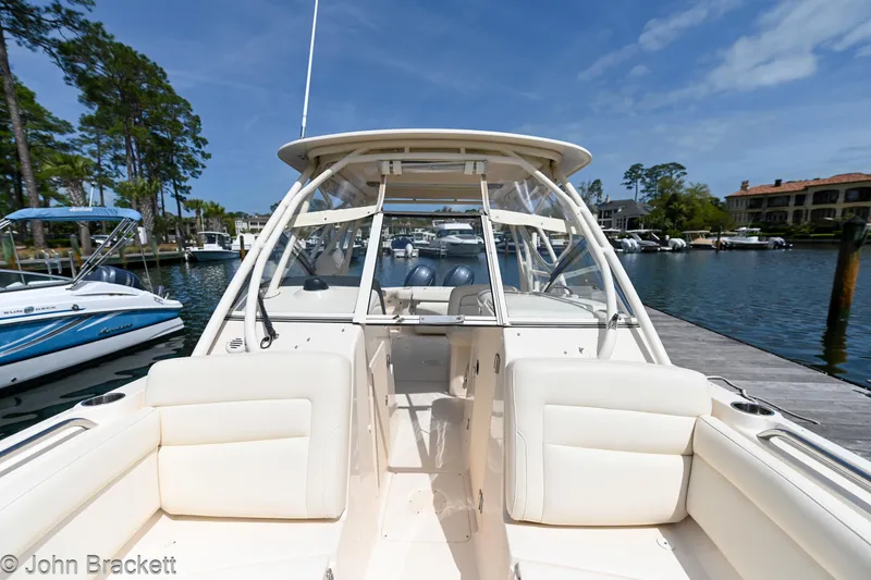  Yacht Photos Pics 2019 Grady-White Freedom 275 boat docked at marina under clear blue sky.