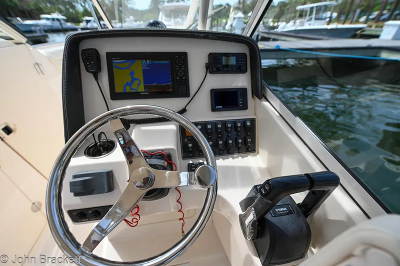  Yacht Photos Pics 2019 Grady-White Freedom 275 boat dashboard with steering wheel and navigation equipment.