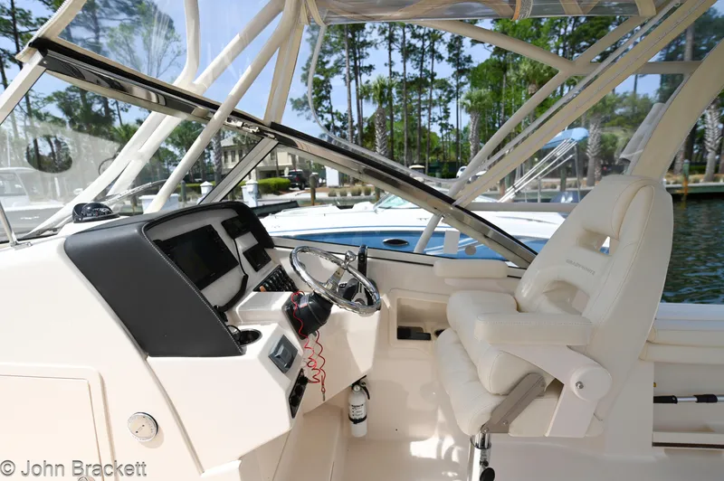  Yacht Photos Pics 2019 Grady-White Freedom 275 boat interior with steering wheel and seating.