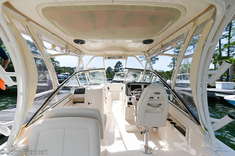  Yacht Photos Pics 2019 Grady-White Freedom 275 boat interior with helm and seating, docked at marina.