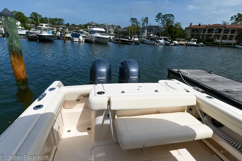  Yacht Photos Pics 2019 Grady-White Freedom 275 boat docked in a marina with twin engines.
