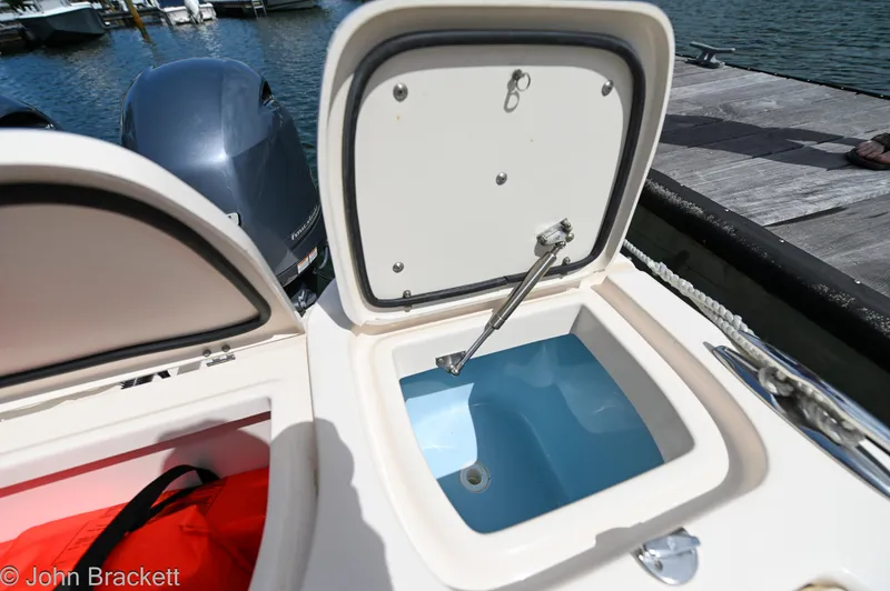  Yacht Photos Pics Open storage compartment on 2019 Grady-White Freedom 275 boat by the dock.