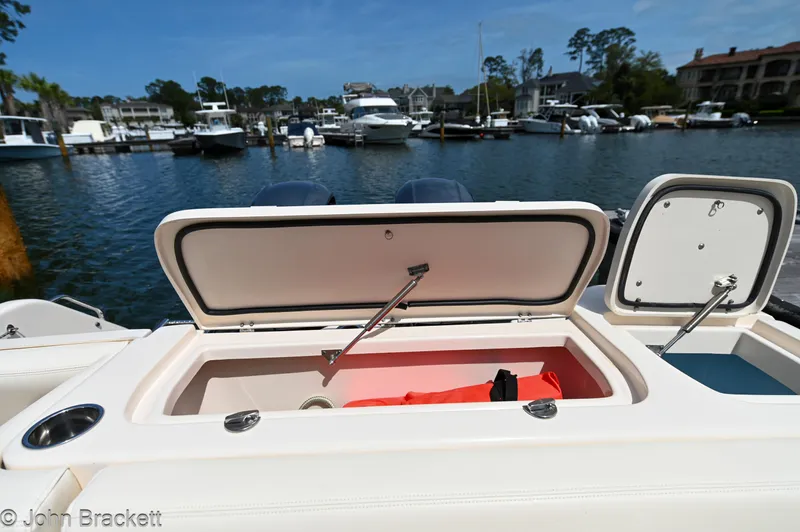  Yacht Photos Pics 2019 Grady-White Freedom 275 boat with open storage compartment at marina.