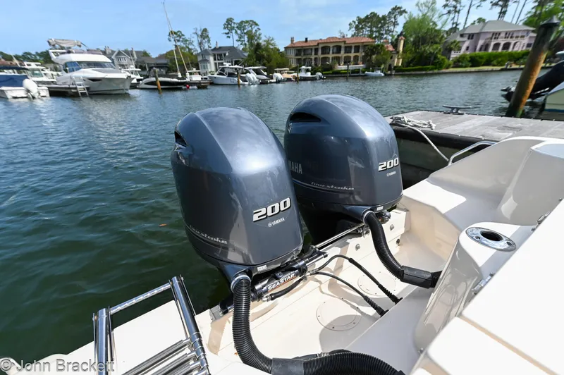  Yacht Photos Pics Twin Yamaha 200 engines on a 2019 Grady-White Freedom 275 boat docked by waterfront homes.