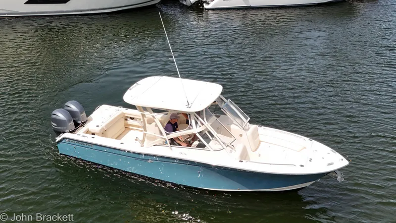  Yacht Photos Pics 2019 Grady-White Freedom 275 boat cruising on water with dual engines.