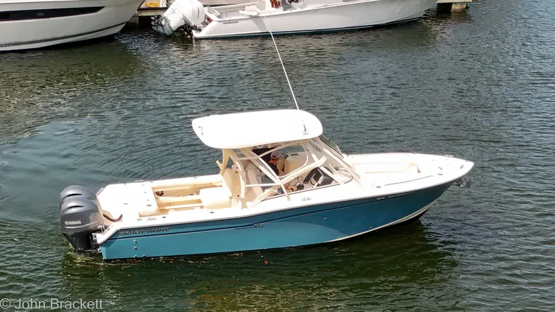  Yacht Photos Pics 2019 Grady-White Freedom 275 boat on water, featuring sleek design and Yamaha engines.