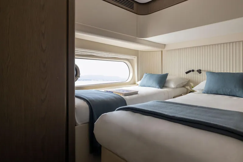  Yacht Photos Pics 2024 Azimut Magellano 60 yacht cabin with twin beds and ocean view window.