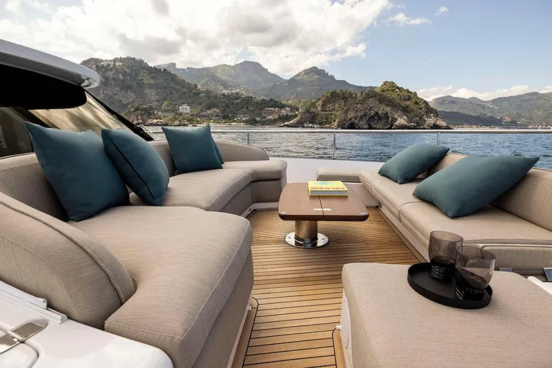  Yacht Photos Pics Luxurious 2024 Azimut Magellano 60 yacht deck with plush seating and scenic ocean view.