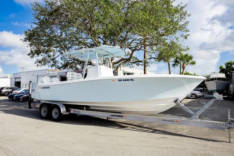  Yacht Photos Pics 2024 Contender 28 Tournament boat on trailer, parked outdoors under a tree.