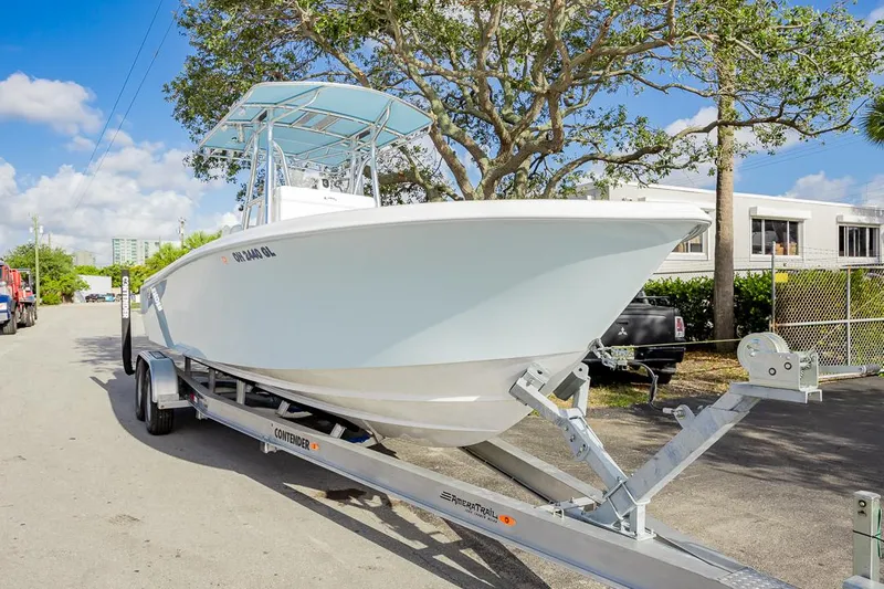  Yacht Photos Pics 2024 Contender 28 Tournament boat on trailer, parked outdoors under a clear blue sky.