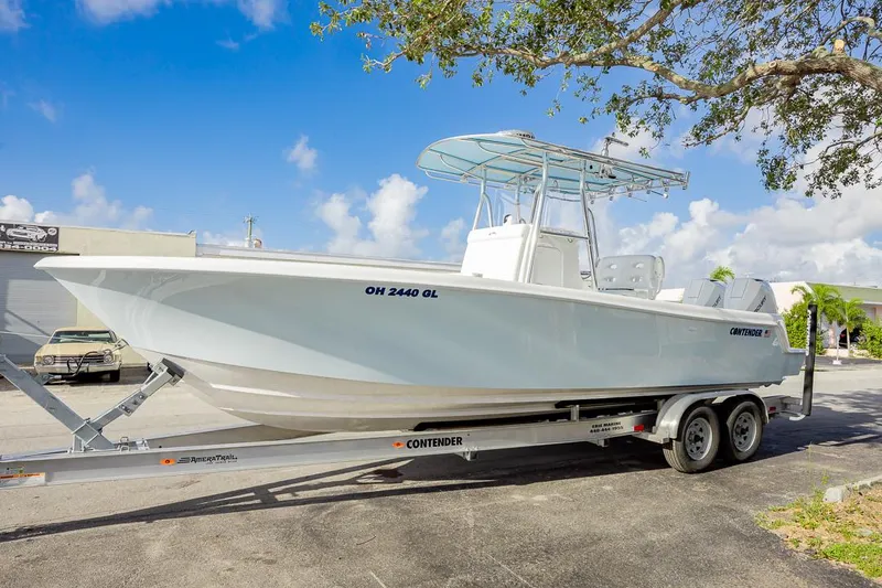  Yacht Photos Pics 2024 Contender 28 Tournament boat on trailer, parked outdoors under a clear blue sky.