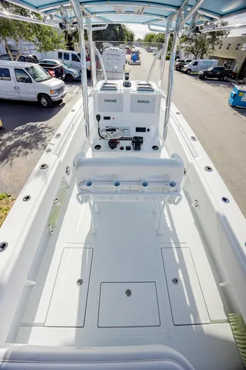  Yacht Photos Pics 2024 Contender 28 Tournament boat interior with console and seating, parked on street.
