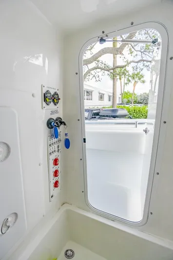  Yacht Photos Pics 2024 Contender 28 Tournament boat interior with control panel and open hatch.