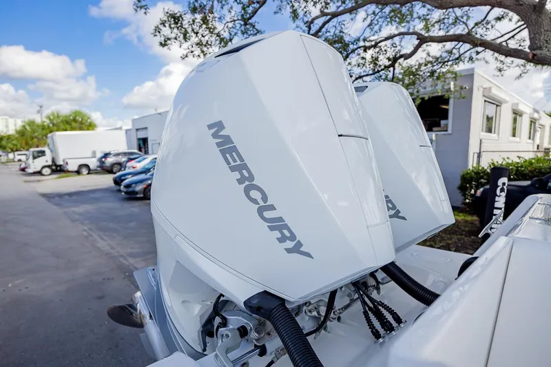  Yacht Photos Pics 2024 Contender 28 Tournament with dual Mercury outboard engines, parked outdoors.