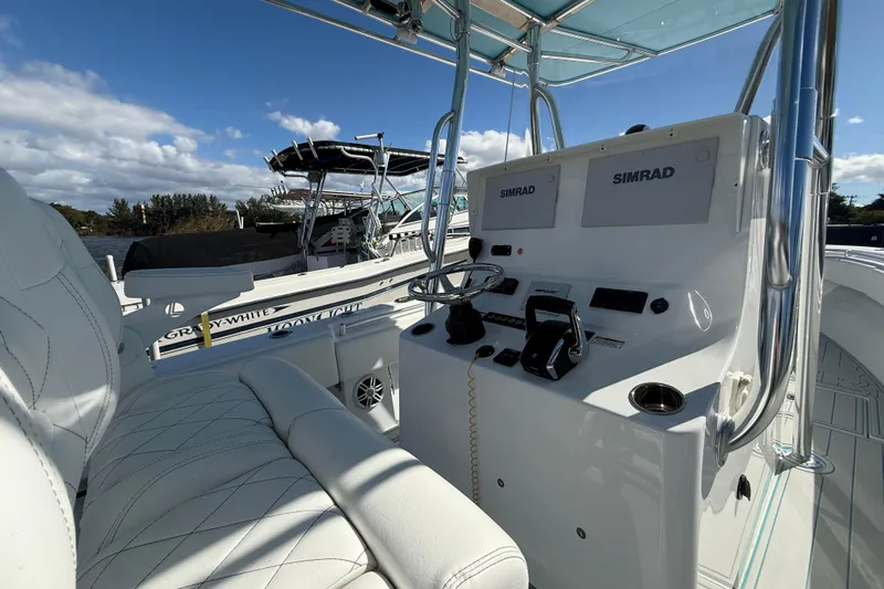  Yacht Photos Pics 2024 Contender 28 Tournament boat interior with Simrad electronics and white seating.