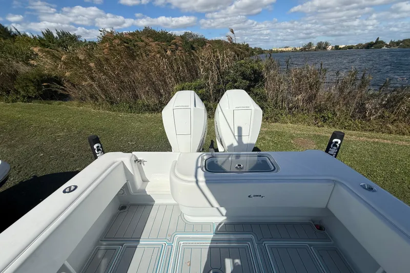  Yacht Photos Pics 2024 Contender 28 Tournament boat with twin engines, docked by a scenic lake.