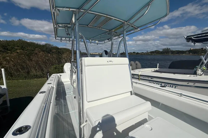  Yacht Photos Pics 2024 Contender 28 Tournament boat with sleek design, docked by a scenic waterfront.