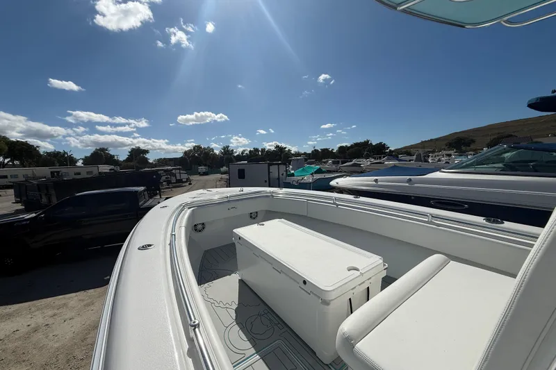  Yacht Photos Pics 2024 Contender 28 Tournament boat, spacious deck, sunny day, marina background.