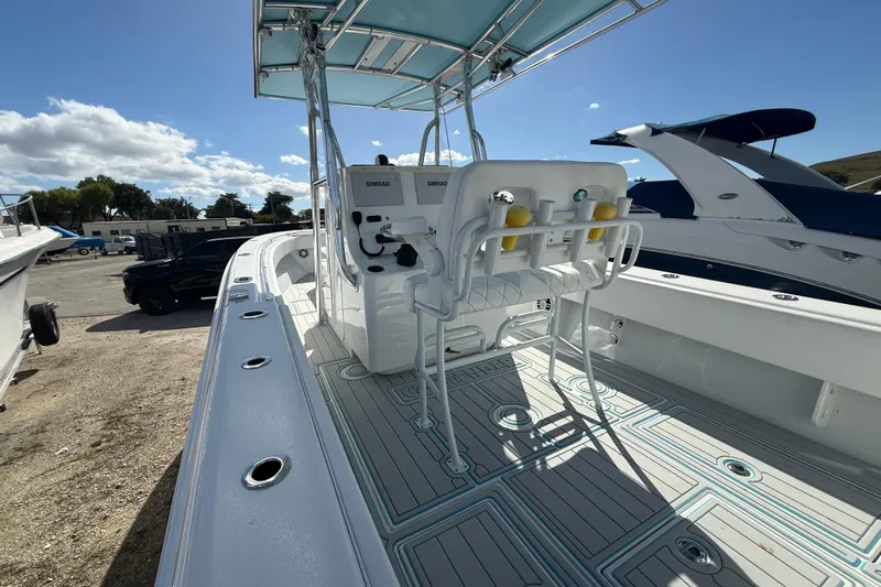  Yacht Photos Pics 2024 Contender 28 Tournament boat interior with helm and seating, under clear blue sky.