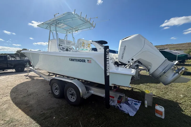  Yacht Photos Pics 2024 Contender 28 Tournament boat on trailer with Mercury outboard engine, parked outdoors.