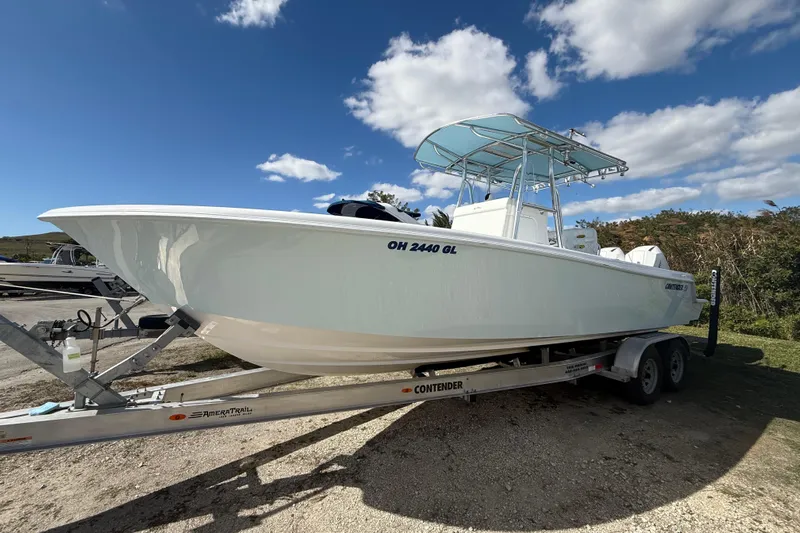  Yacht Photos Pics 2024 Contender 28 Tournament boat on trailer under blue sky.