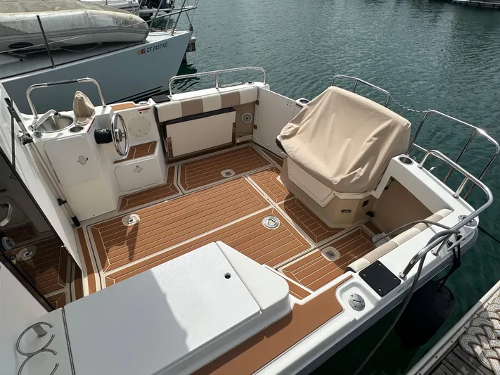 Cutwater 28 Yacht Photos Pics 2016 Cutwater 28 boat with spacious deck and covered seating, docked at marina.