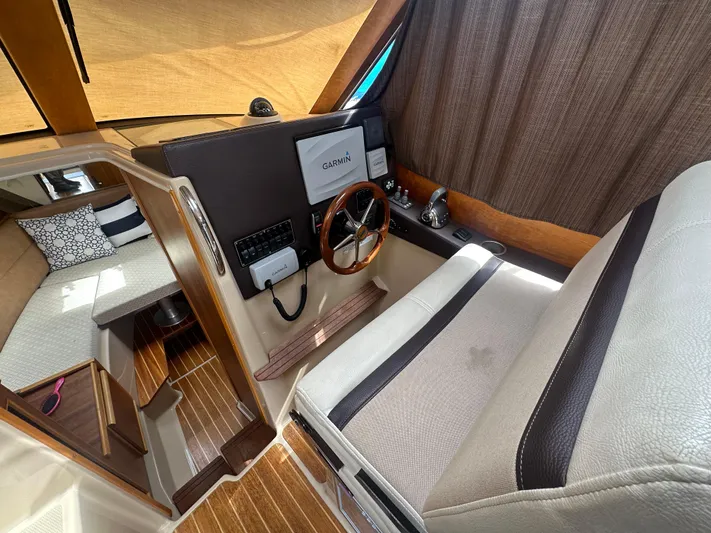 Cutwater 28 Yacht Photos Pics Interior of 2016 Cutwater 28 boat with steering wheel and navigation equipment.