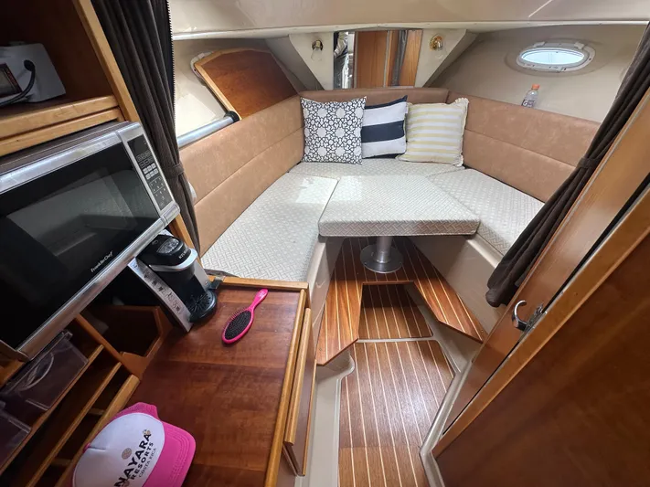 Cutwater 28 Yacht Photos Pics 2016 Cutwater 28 interior with cozy seating, microwave, and wooden flooring.