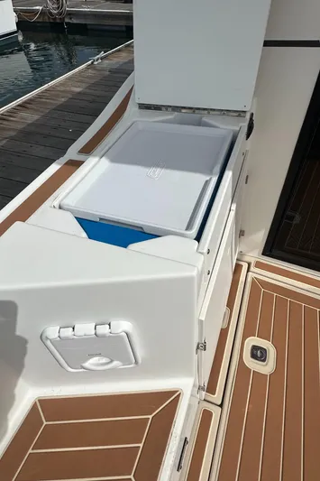 Cutwater 28 Yacht Photos Pics 2016 Cutwater 28 boat deck with storage compartment and wooden flooring.