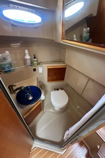 Cutwater 28 Yacht Photos Pics 2016 Cutwater 28 boat bathroom with sink, toilet, and storage.