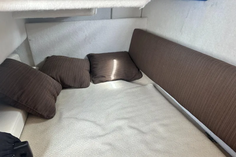 Cutwater 28 Yacht Photos Pics Cozy interior cabin of 2016 Cutwater 28 boat with brown cushions.