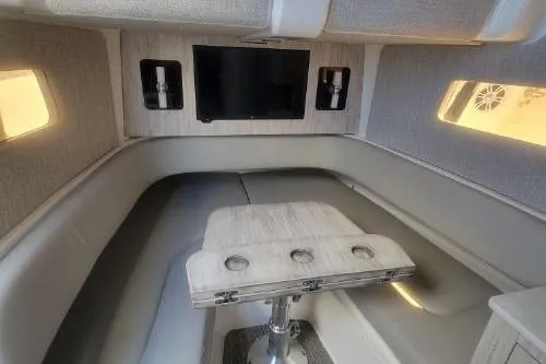  Yacht Photos Pics 2022 Regulator 41 boat interior with seating, table, and mounted TV.